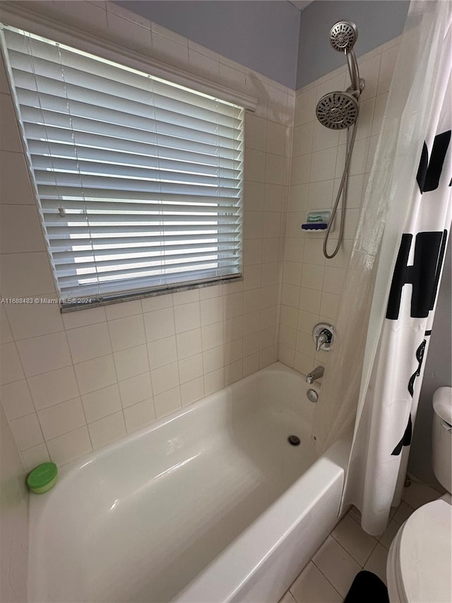 bathroom with toilet, shower / tub combo, and tile patterned floors