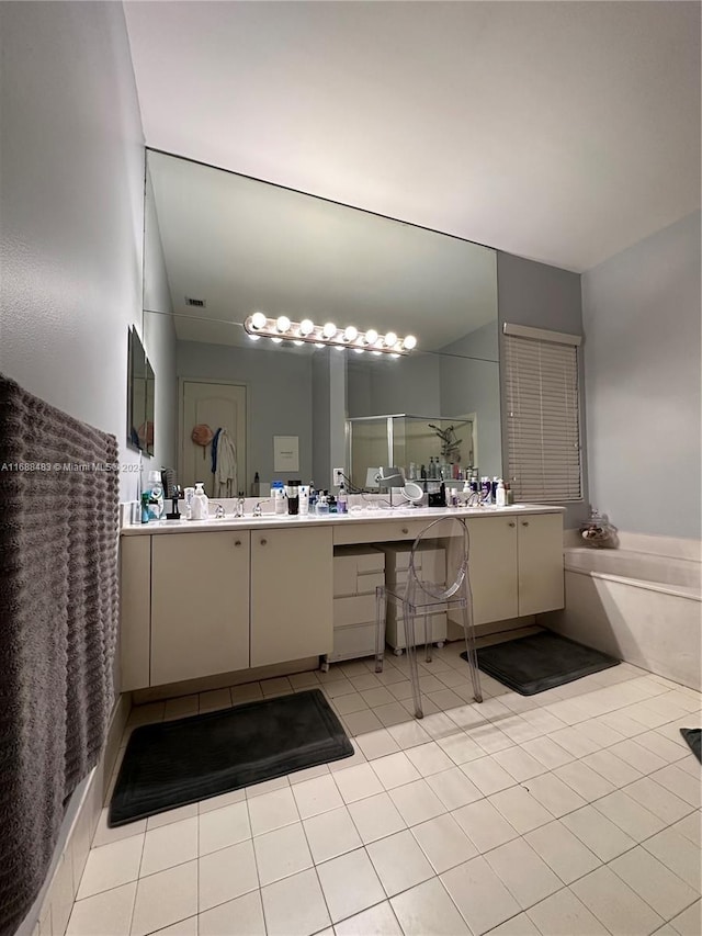 bathroom featuring independent shower and bath, vanity, and tile patterned flooring