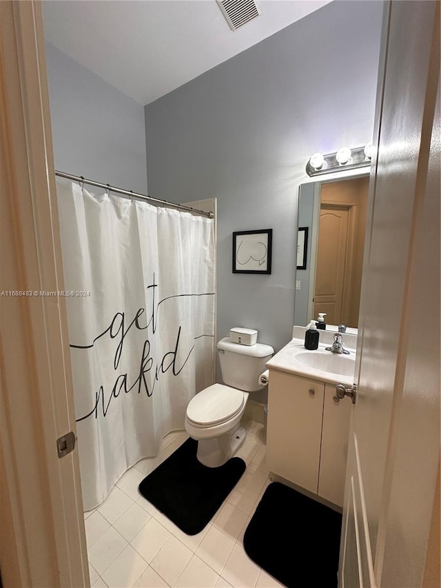 bathroom with tile patterned flooring, vanity, and toilet