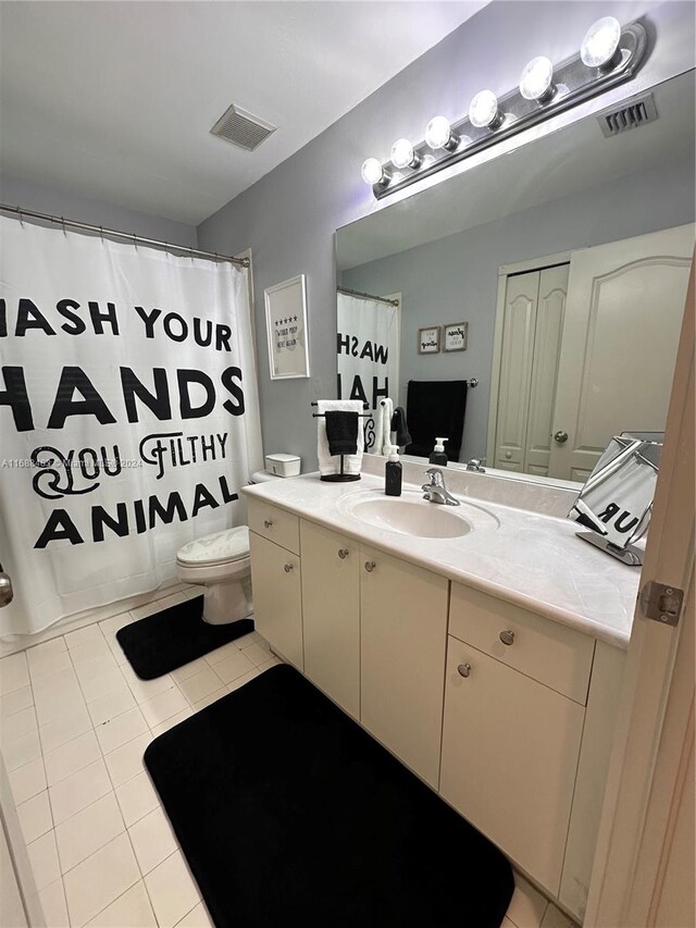 bathroom with toilet, vanity, a shower with shower curtain, and tile patterned flooring