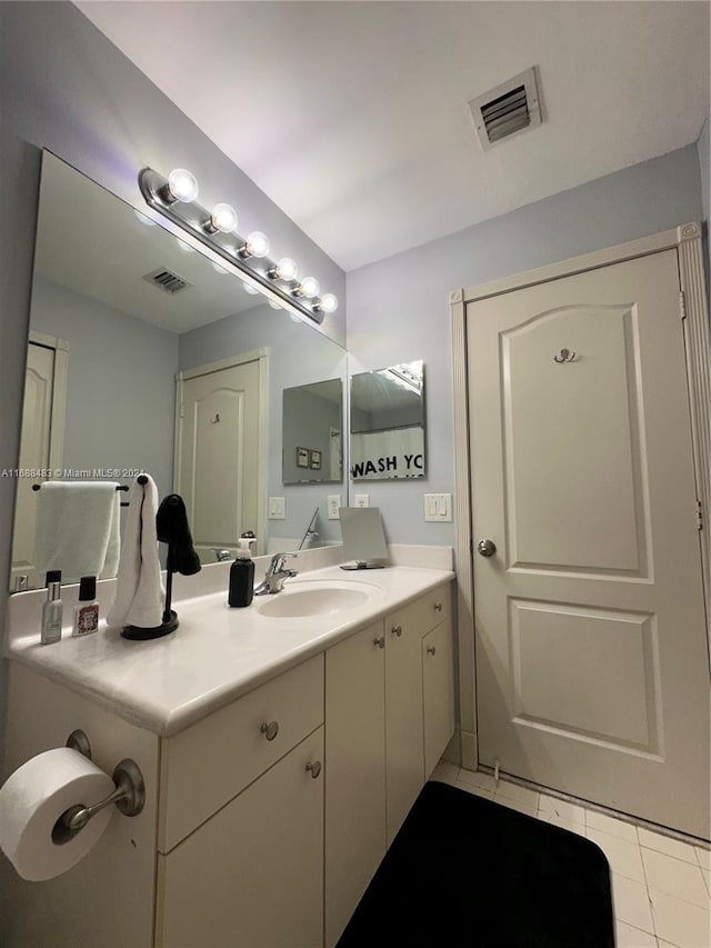 bathroom with vanity and tile patterned floors