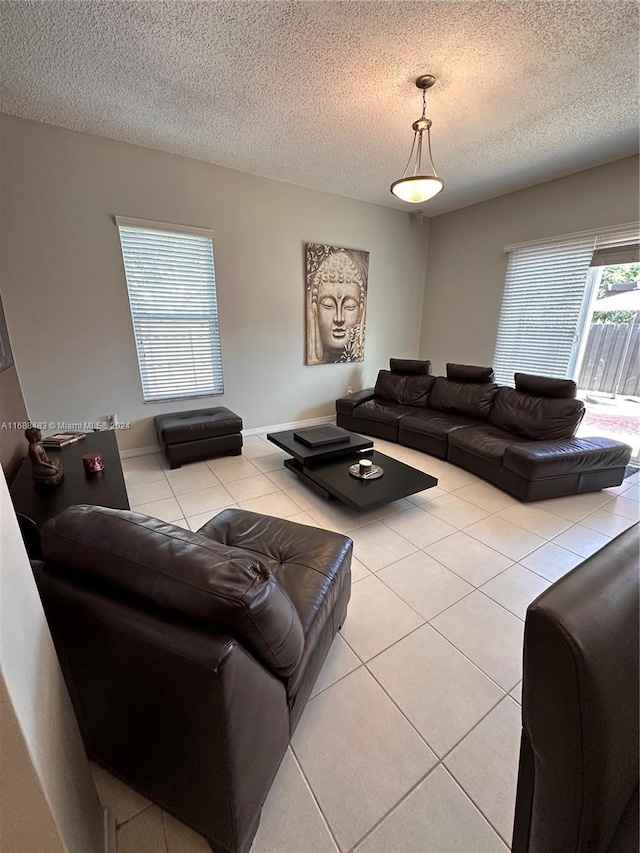 living room with a textured ceiling and light tile patterned floors