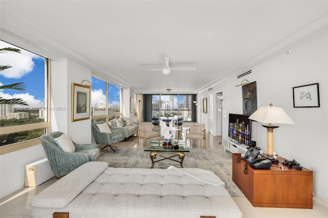 tiled living room featuring ceiling fan and crown molding