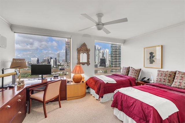 carpeted bedroom with multiple windows, ornamental molding, and ceiling fan