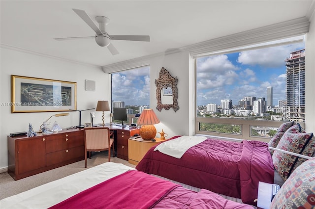 bedroom featuring ceiling fan, light colored carpet, and ornamental molding