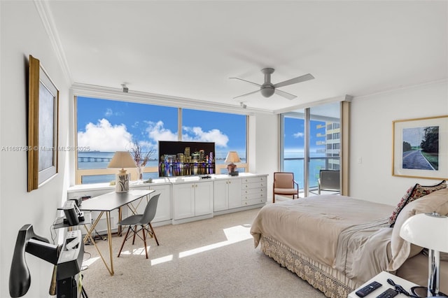 carpeted bedroom featuring access to outside, a wall of windows, ceiling fan, and ornamental molding