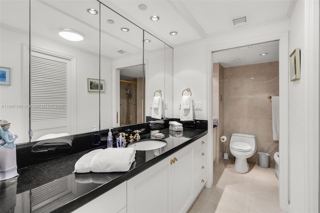 bathroom featuring tile patterned flooring, vanity, toilet, and crown molding