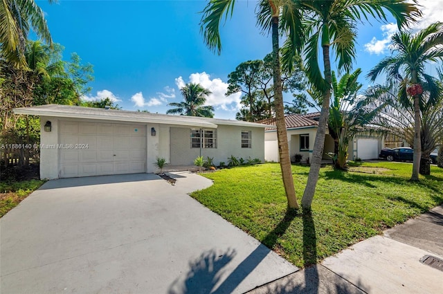 ranch-style home with a garage and a front lawn