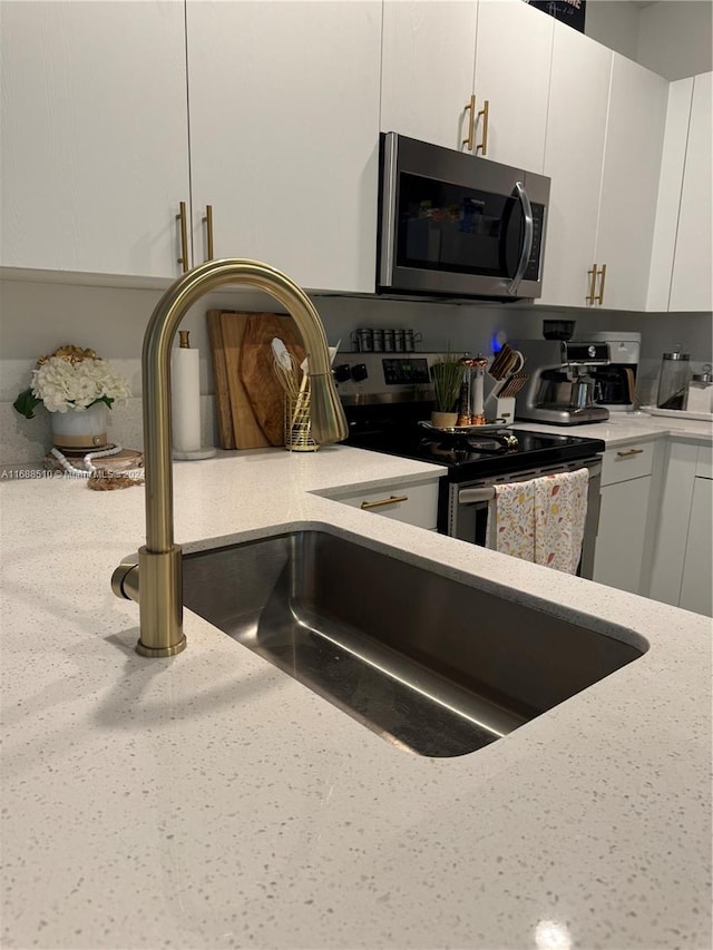 kitchen featuring white cabinetry, sink, and stainless steel appliances