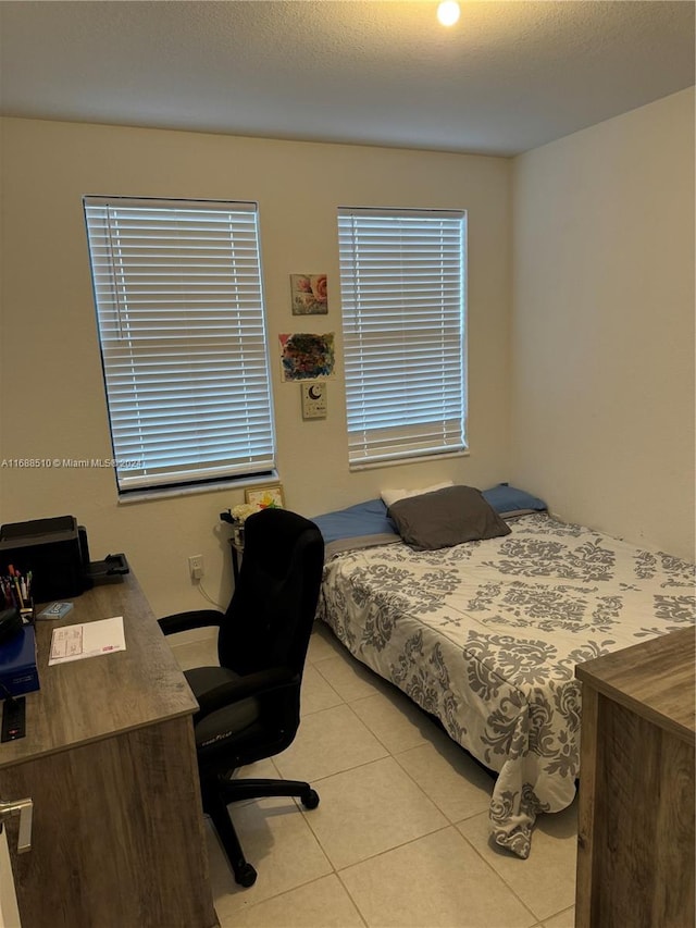 tiled bedroom with a textured ceiling