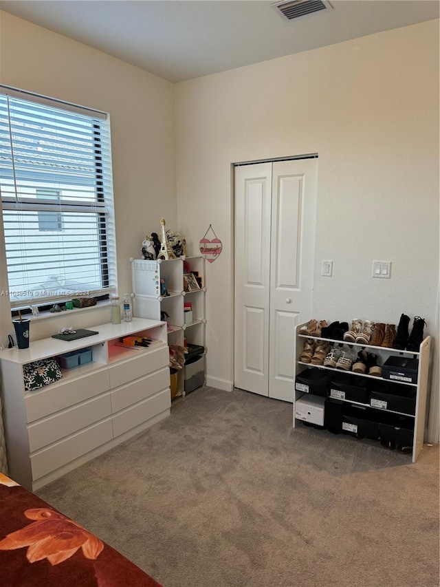 carpeted bedroom featuring a closet