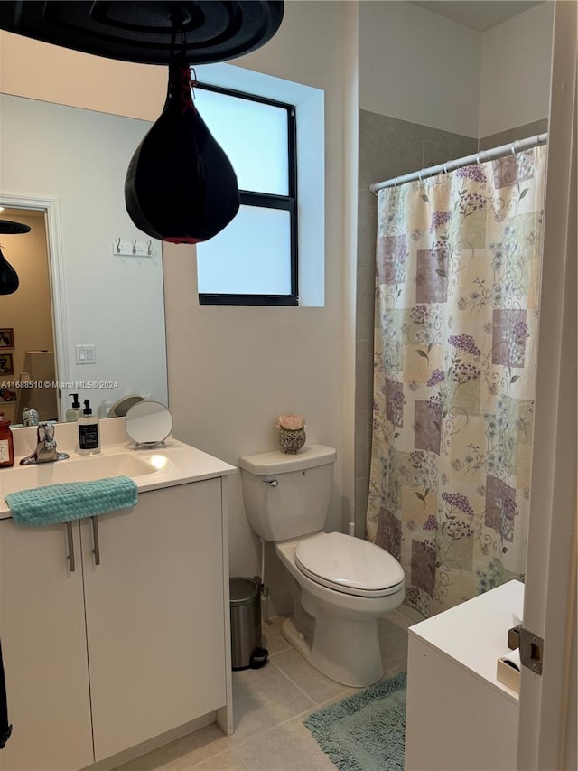 bathroom featuring curtained shower, vanity, tile patterned floors, and toilet