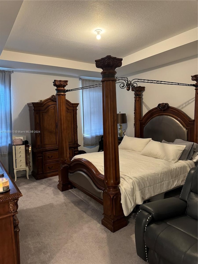 carpeted bedroom with a textured ceiling