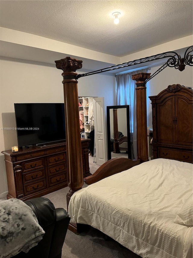 carpeted bedroom featuring a textured ceiling