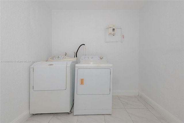 clothes washing area featuring separate washer and dryer