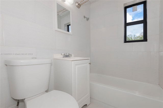 full bathroom featuring tile walls, vanity, toilet, and tiled shower / bath