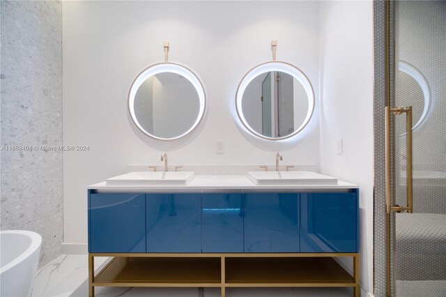2655 S Bayshore Dr Unit 1602, Coconut Grove, FL 33133 - full bathroom with double vanity, marble look tiles, a stall shower, a freestanding tub, and baseboards