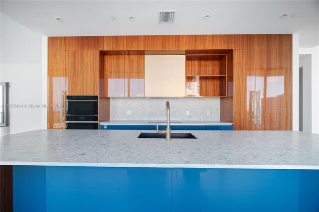 2655 S Bayshore Dr Unit 1602, Coconut Grove, FL 33133 - kitchen featuring a sink, tasteful backsplash, light stone countertops, modern cabinets, and open shelves