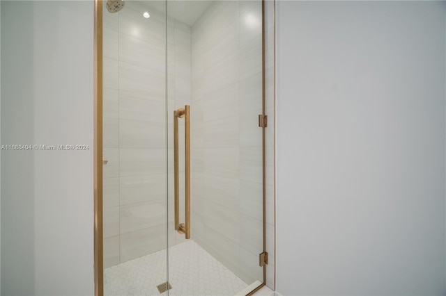 bathroom featuring a shower with shower door