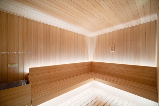 view of sauna / steam room with wood ceiling and wooden walls