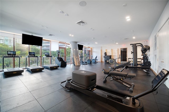 exercise room with floor to ceiling windows