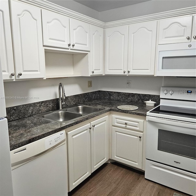 kitchen with white appliances and white cabinets