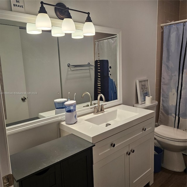 bathroom with hardwood / wood-style flooring, vanity, and toilet