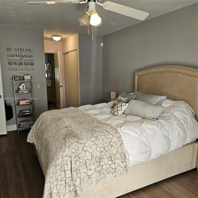 bedroom featuring dark wood-type flooring, ceiling fan, and a closet