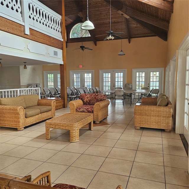 living room with light tile patterned floors, beam ceiling, high vaulted ceiling, wood ceiling, and ceiling fan