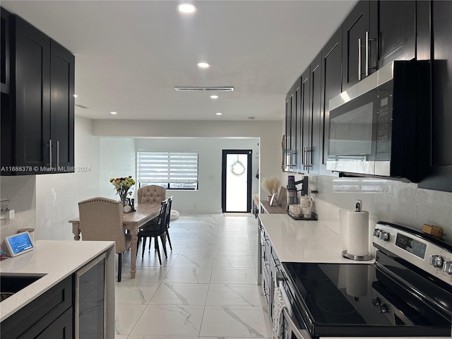 kitchen featuring beverage cooler and appliances with stainless steel finishes