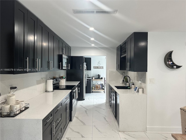 kitchen with sink, decorative backsplash, and appliances with stainless steel finishes