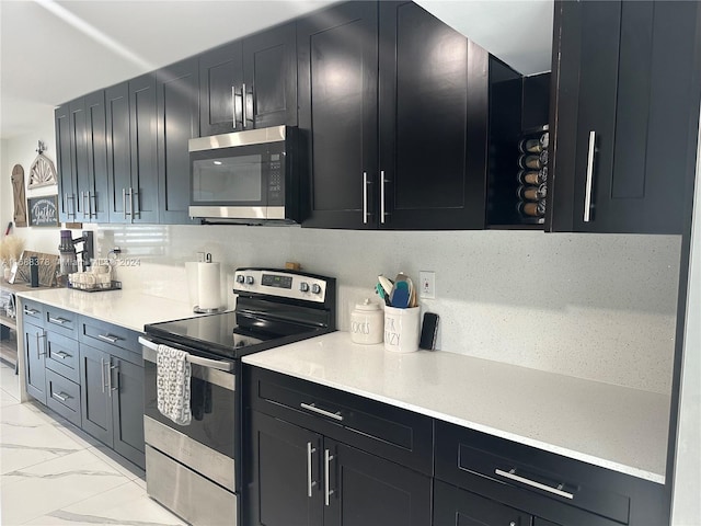 kitchen with backsplash and stainless steel appliances