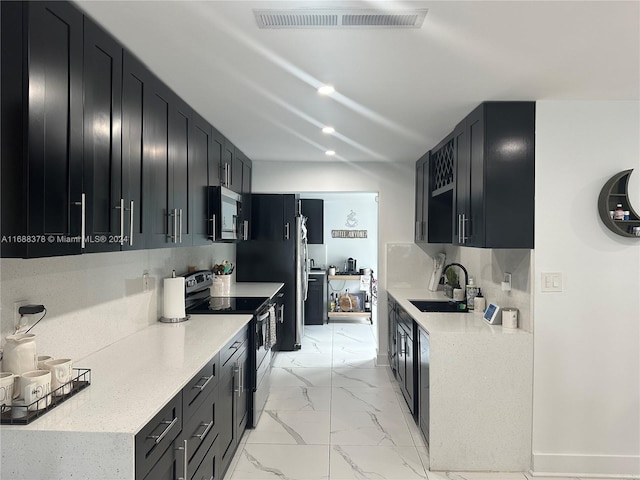 kitchen with decorative backsplash, stainless steel appliances, and sink