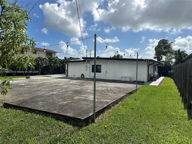 back of property featuring a patio and a yard