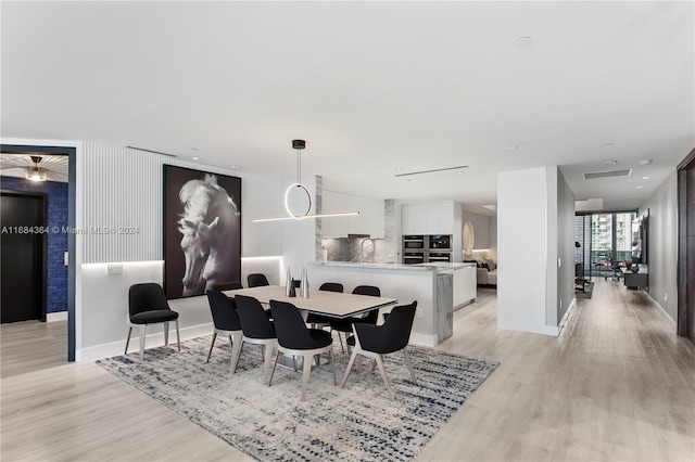 dining area featuring sink and light hardwood / wood-style flooring