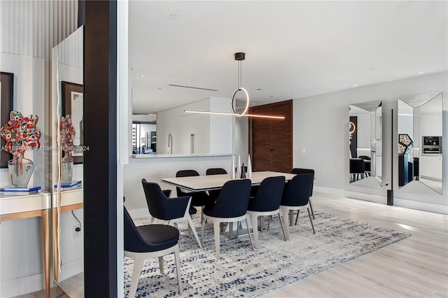 dining space featuring light wood-type flooring