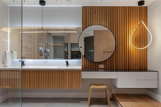 bathroom with vanity and a shower with door