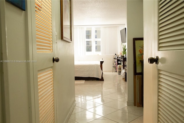 bedroom featuring a textured ceiling and light tile patterned flooring