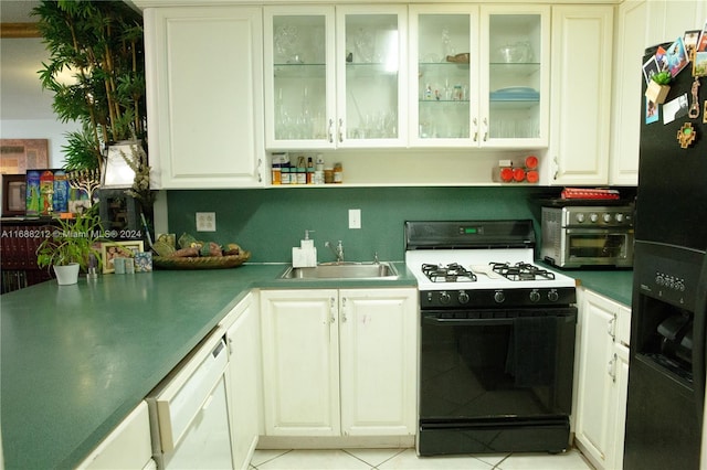 kitchen with black refrigerator with ice dispenser, range with gas stovetop, white cabinetry, and sink