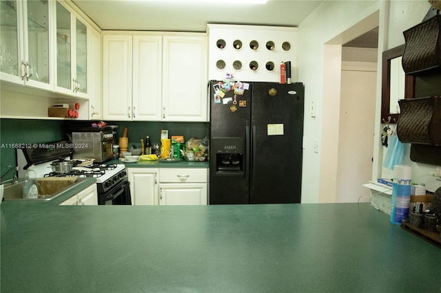 kitchen featuring white cabinetry and black appliances