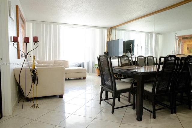 tiled dining area featuring a textured ceiling