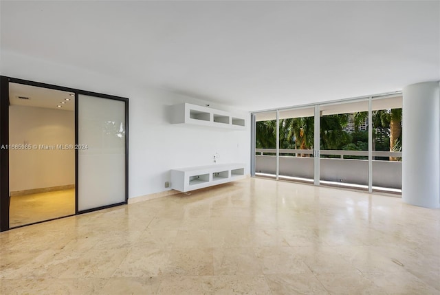 unfurnished living room with expansive windows