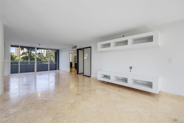 unfurnished living room featuring floor to ceiling windows