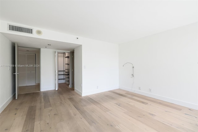 spare room featuring light hardwood / wood-style flooring