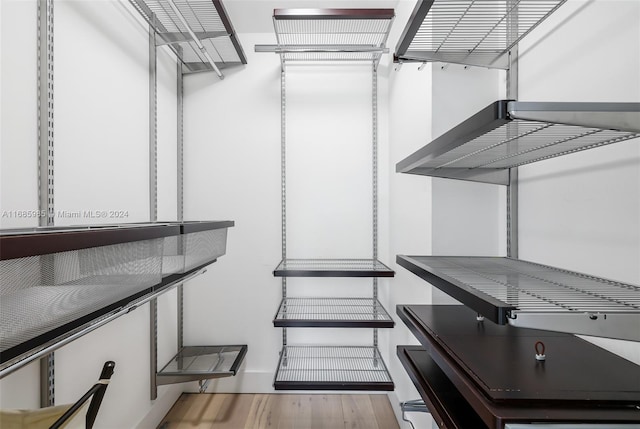 spacious closet featuring hardwood / wood-style flooring