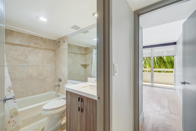 full bathroom with vanity, hardwood / wood-style flooring, toilet, and shower / bath combo with shower curtain