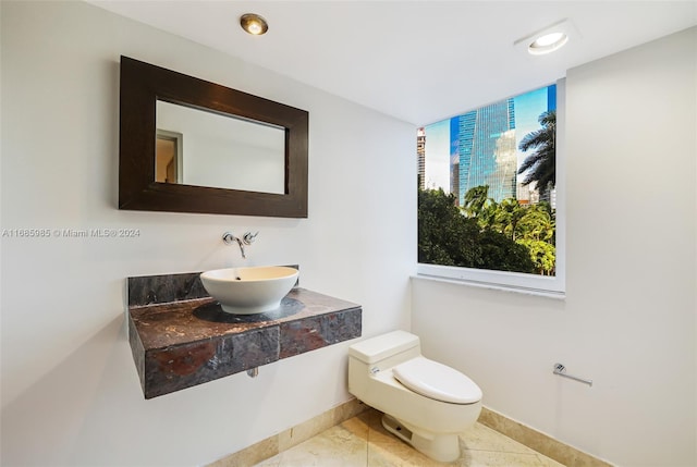 bathroom with tile patterned floors, toilet, and sink