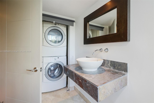 clothes washing area with sink and stacked washing maching and dryer