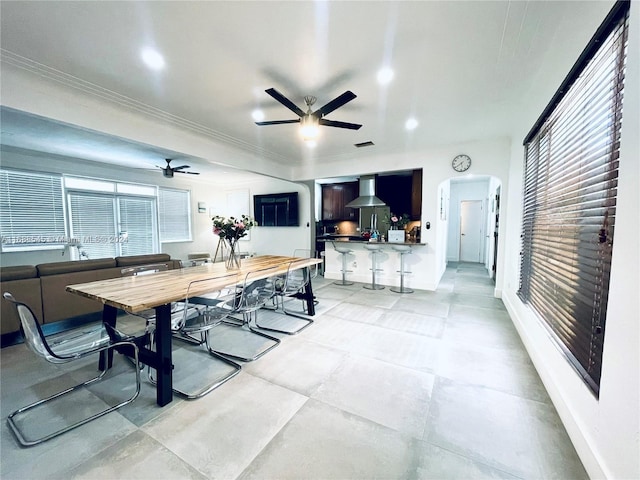 dining space featuring ceiling fan and ornamental molding