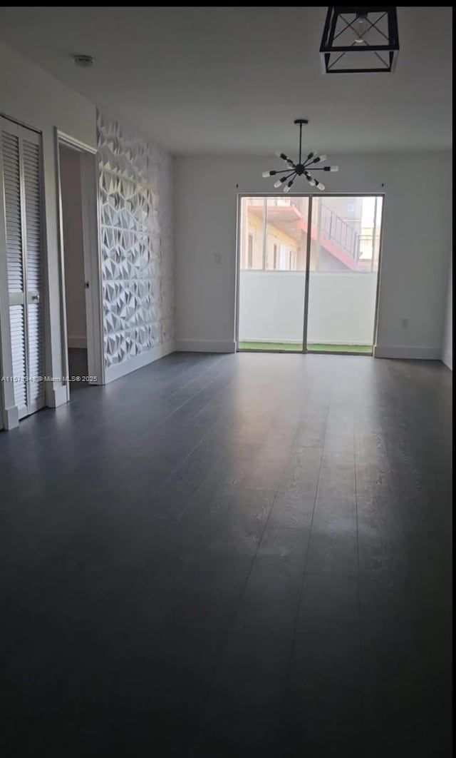 unfurnished room with a chandelier